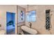 Elegant bathroom with a soaking tub, a modern shower system, and stylish marble-look tile at 523 Cascading Creek Ln, Winter Garden, FL 34787
