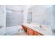 Bathroom featuring a shower-tub combo, large mirror, and a door to the toilet at 523 Cascading Creek Ln, Winter Garden, FL 34787