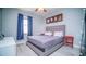 Bedroom featuring hardwood floors, a large window, and a comfortable-looking bed at 523 Cascading Creek Ln, Winter Garden, FL 34787