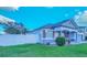 Exterior view of home featuring a privacy fence, manicured lawn and shrubbery at 523 Cascading Creek Ln, Winter Garden, FL 34787