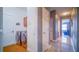 Hallway leading to the living area and laundry room featuring tile floor and access to bedrooms at 523 Cascading Creek Ln, Winter Garden, FL 34787