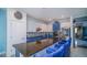 Modern kitchen featuring granite counters, stainless steel appliances and blue and white cabinetry at 523 Cascading Creek Ln, Winter Garden, FL 34787