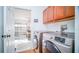 Convenient laundry room with modern washer and dryer, plus adjacent garage access at 523 Cascading Creek Ln, Winter Garden, FL 34787