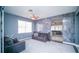 Modern living room featuring a ceiling fan, unique accent wall, and tile flooring at 523 Cascading Creek Ln, Winter Garden, FL 34787