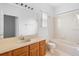 Bathroom featuring a single vanity, and a shower-tub combo with white tile at 536 Kilimanjaro Dr, Kissimmee, FL 34758