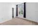 Empty bedroom featuring neutral carpet, a window, and white walls at 536 Kilimanjaro Dr, Kissimmee, FL 34758