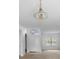 Bright entryway featuring tile flooring and a classic chandelier, leading to the open living spaces at 536 Kilimanjaro Dr, Kissimmee, FL 34758
