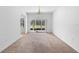 Spacious living room with carpet flooring and sliding glass doors that lead to the patio, providing a seamless indoor-outdoor flow at 536 Kilimanjaro Dr, Kissimmee, FL 34758
