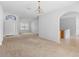 Open-concept living room boasting neutral carpeting, an arched entryway, and plenty of natural light at 536 Kilimanjaro Dr, Kissimmee, FL 34758