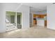 Living room featuring view to kitchen and a sliding door with access to lanai at 536 Kilimanjaro Dr, Kissimmee, FL 34758