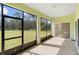 Enclosed patio featuring large windows with views of the surrounding greenery, offering a serene retreat at 536 Kilimanjaro Dr, Kissimmee, FL 34758