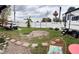 Spacious backyard with green grass, white fence, trailer, and recreation vehicles at 5371 Tribune Dr, Orlando, FL 32812