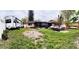 Spacious backyard with a camper, jet skis, and a screened-in porch, perfect for outdoor activities at 5371 Tribune Dr, Orlando, FL 32812