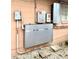 Exterior electrical panels and equipment mounted on a peach brick wall, showcasing the home's power and utility systems at 5371 Tribune Dr, Orlando, FL 32812