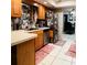 Kitchen featuring light oak cabinets, neutral countertops, stainless steel appliances, and tiled floors at 5371 Tribune Dr, Orlando, FL 32812