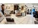 Spacious living room featuring tile floors, recliners, and decorative wall hangings providing a comfortable gathering space at 5371 Tribune Dr, Orlando, FL 32812