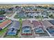 This aerial view showcases lovely homes with screened pools in a well-kept neighborhood with mature landscaping at 551 Majesty Dr, Davenport, FL 33837