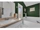 Bathroom featuring a combined tub and shower, green walls, and white marbled floors at 551 Majesty Dr, Davenport, FL 33837