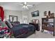 Bedroom showcasing dark wood furniture, a large TV, and a light ceiling fan at 551 Majesty Dr, Davenport, FL 33837