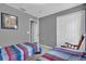 Bedroom featuring two beds with matching spreads, closet and a vintage rocking chair at 551 Majesty Dr, Davenport, FL 33837