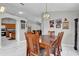 Cozy dining room featuring a wooden table set, adjacent to the kitchen and living area at 551 Majesty Dr, Davenport, FL 33837