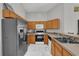Well-equipped kitchen featuring modern appliances, wooden cabinets, and durable countertops at 551 Majesty Dr, Davenport, FL 33837