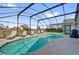 Relaxing screened-in pool area with lounge chairs offering a serene outdoor retreat at 551 Majesty Dr, Davenport, FL 33837