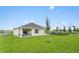 A spacious backyard featuring a covered patio, well-maintained lawn, and attractive landscaping at 5852 Galloping Dr, Apopka, FL 32712