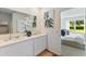 Elegant bathroom with double sinks, white cabinets, and a view into a bedroom with natural light at 5852 Galloping Dr, Apopka, FL 32712