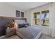 Cozy bedroom featuring a striped bedspread, football decor, and a bright window overlooking the outdoors at 5852 Galloping Dr, Apopka, FL 32712