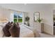 Comfortable bedroom featuring neutral décor, soft lighting, and a view of the outdoors at 5852 Galloping Dr, Apopka, FL 32712