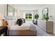 Inviting bedroom with a large window, plush bed, and neutral tones, creating a serene and comfortable atmosphere at 5852 Galloping Dr, Apopka, FL 32712