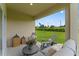 Stylish covered patio with modern furniture and a serene view of the landscaped backyard at 5852 Galloping Dr, Apopka, FL 32712