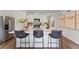 Modern kitchen featuring a center island with bar stools, white cabinets and stainless steel appliances at 5852 Galloping Dr, Apopka, FL 32712
