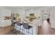 Spacious open kitchen with white cabinets, stainless steel appliances, and a large center island with bar seating at 5852 Galloping Dr, Apopka, FL 32712