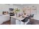 Open kitchen with white cabinets, stainless steel appliances, and a center island with seating at 5852 Galloping Dr, Apopka, FL 32712