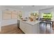 Bright, modern kitchen with a central island, white cabinetry, and stainless steel appliances at 5852 Galloping Dr, Apopka, FL 32712