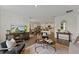 Open-concept living room with contemporary decor, hardwood floors, and ample natural light at 5852 Galloping Dr, Apopka, FL 32712