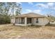 Rear view of house with screened in patio and a large, dry backyard at 600 Marion Oaks Blvd, Ocala, FL 34473