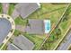 Birds eye view of a house with a pool, patio, and well-manicured landscaping surrounded by other homes at 6105 Citrus Grove Ct, St Cloud, FL 34771
