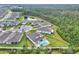 Aerial view of a private pool and patio in a well-maintained community with lush landscaping and a serene pond at 6105 Citrus Grove Ct, St Cloud, FL 34771