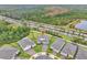 Aerial view of homes in a meticulously landscaped community with manicured lawns and a view of a beautiful pond at 6105 Citrus Grove Ct, St Cloud, FL 34771