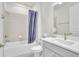 Modern bathroom featuring a tub with shower and gray vanity at 6105 Citrus Grove Ct, St Cloud, FL 34771
