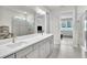 Bright bathroom featuring double vanity, tile flooring, glass shower, and modern fixtures at 6105 Citrus Grove Ct, St Cloud, FL 34771