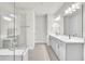 Bright bathroom with double vanity, quartz countertops, glass shower, and modern fixtures at 6105 Citrus Grove Ct, St Cloud, FL 34771