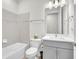 Modern bathroom featuring a tub with shower and gray vanity at 6105 Citrus Grove Ct, St Cloud, FL 34771