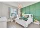 Well-lit bedroom showcasing a bed, desk, decorative wall, and hardwood floors at 6105 Citrus Grove Ct, St Cloud, FL 34771
