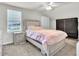 This bedroom includes a bed, ceiling fan, and a large window with blinds at 6105 Citrus Grove Ct, St Cloud, FL 34771