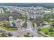 Aerial view of a manicured community entrance, highlighting landscaping, water feature and the welcoming feel at 6105 Citrus Grove Ct, St Cloud, FL 34771