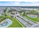 Aerial view of the neighborhood entrance, showcasing beautifully maintained landscaping, water fountains and a calm lake at 6105 Citrus Grove Ct, St Cloud, FL 34771